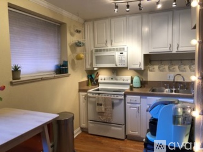 A kitchen with white cabinets and stainless steel appliances.