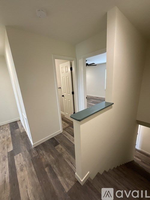 A room with a wooden floor and a green countertop.