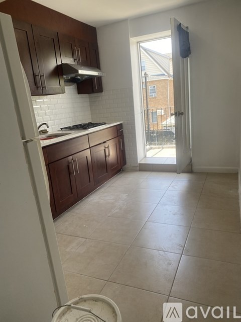 A kitchen with brown cabinets and a white refrigerator.
