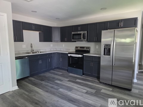 A kitchen with dark wood cabinets and stainless steel appliances.
