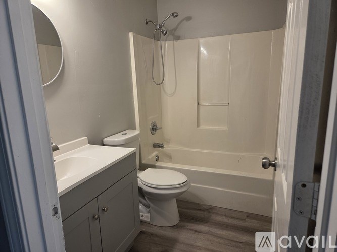 A bathroom with a toilet, sink, and bathtub.