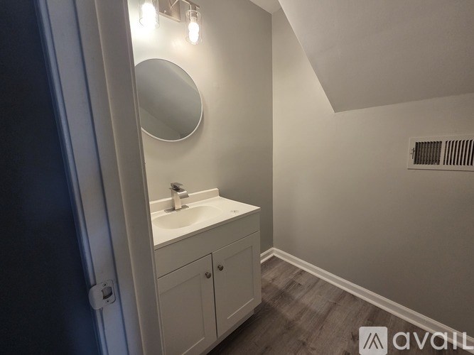 A bathroom with a sink and a mirror.