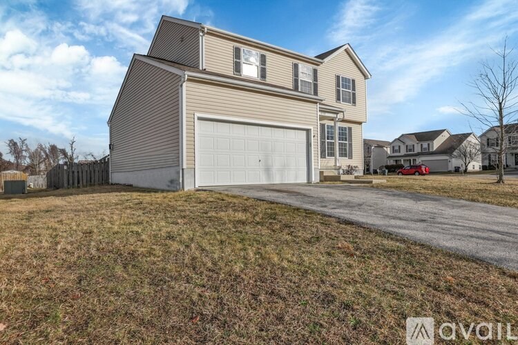 A two-story house with a garage is available for sale.