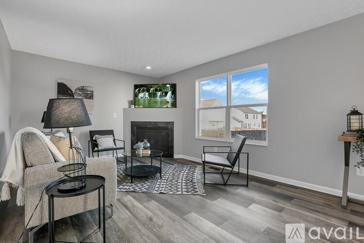 A living room with a grey sofa, a black coffee table, and a fireplace.