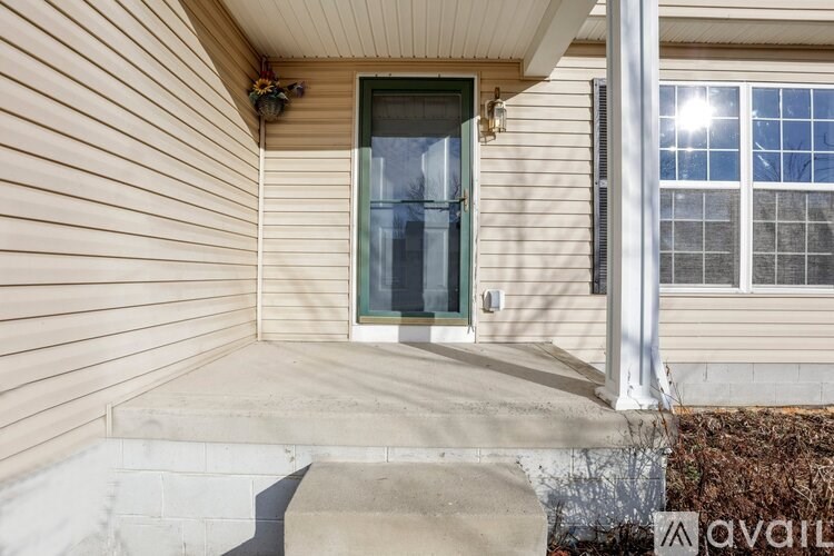 A house with a green door and a window with a white frame.
