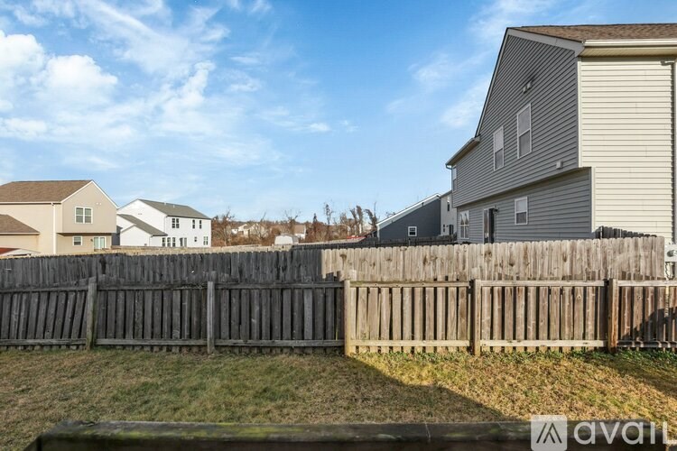 A row of houses with a wooden fence in front.