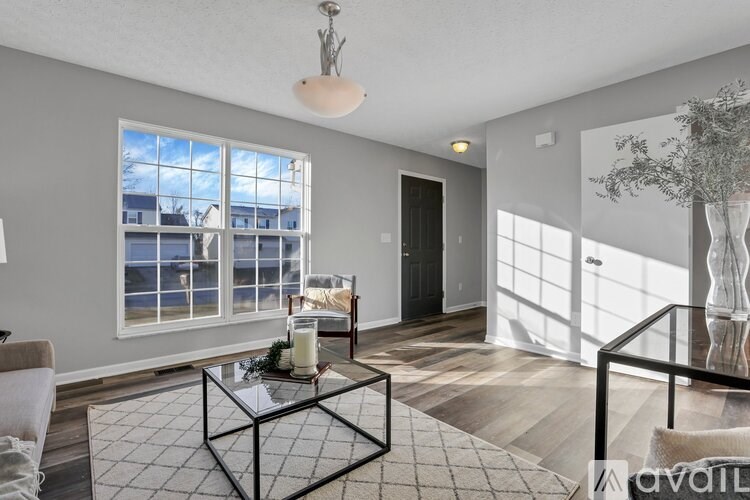 A living room with a glass table and a sofa.