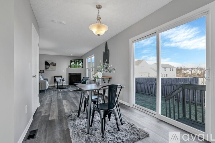 A dining room with a table and chairs is shown.