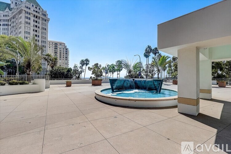 A pool area with a blue pool surrounded by white columns.