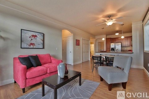 A living room with a red couch and a coffee table.
