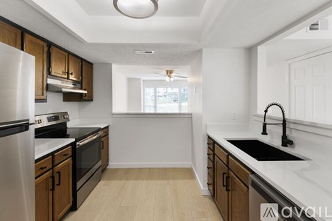 A kitchen with wooden cabinets and a white refrigerator.