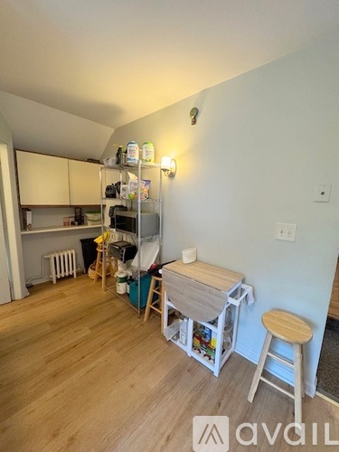 A kitchen with white cabinets and a granite countertop.