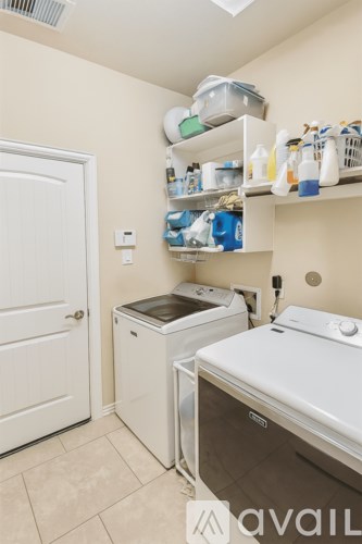 A small laundry room with a washer and dryer.