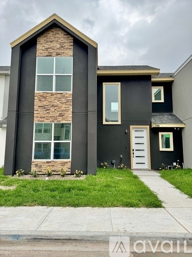 A black house with a white door and windows.