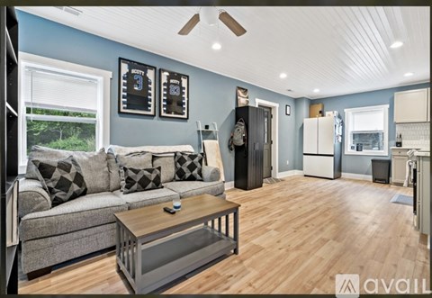 A living room with a grey couch and a wooden coffee table.