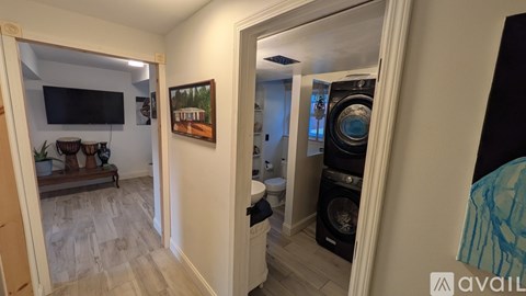 A living room with a flat screen TV and a painting on the wall.