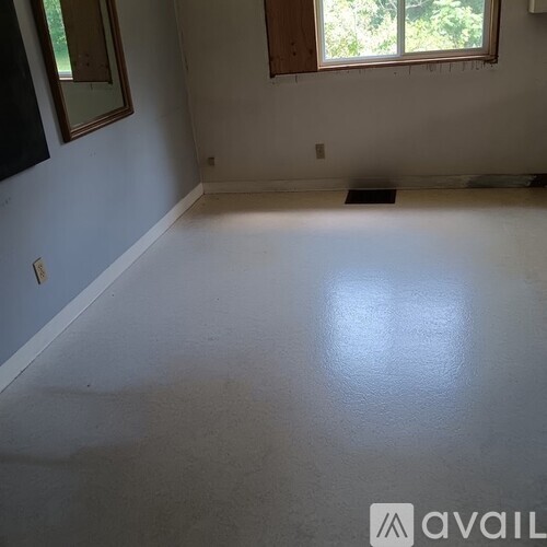 A room with white walls and a checkered floor.