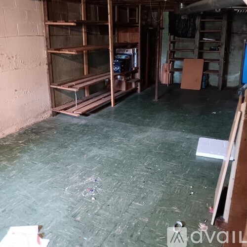 A room with wooden shelves and a green floor.