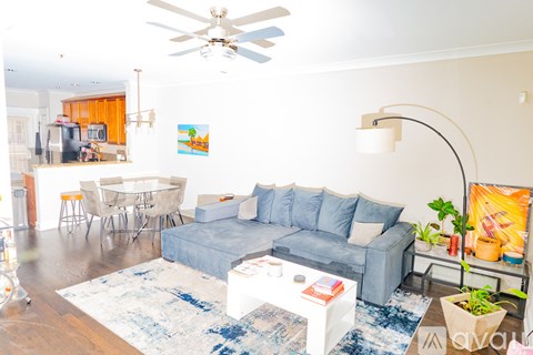 A living room with a grey couch and a white coffee table.