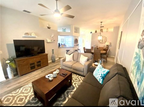 A living room with a brown couch and a wooden coffee table.