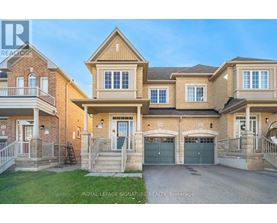 A large, two-story house with a garage is for sale.