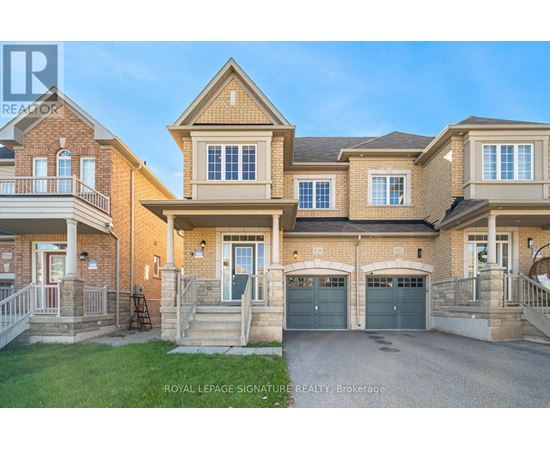 A large, two-story house with a garage is for sale.