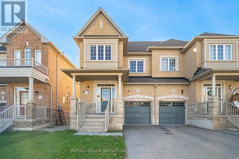 A large, two-story house with a garage is for sale.