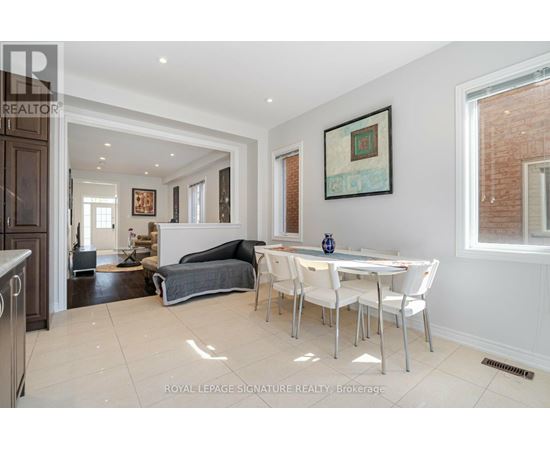 A white dining room with a table and chairs.