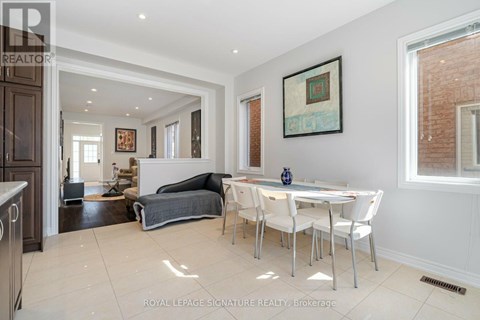 A white dining room with a table and chairs.