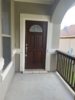 A brown door with a glass window above it.