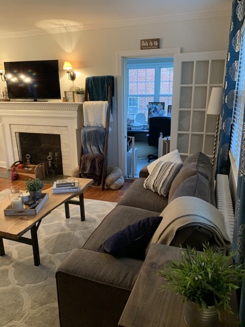A living room with a grey couch and a coffee table.