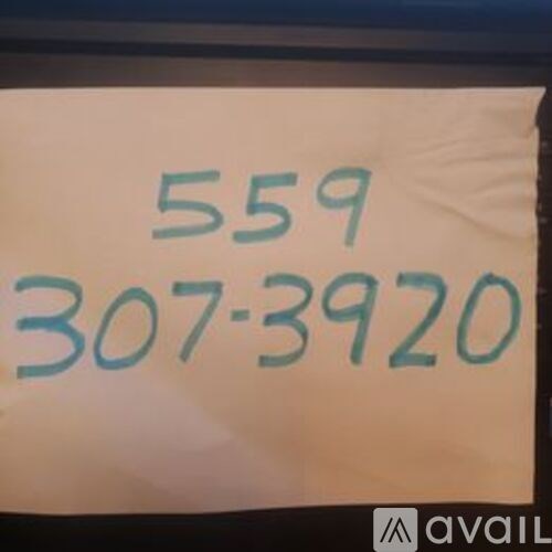 A white sign with the numbers 559 and 307-3920 written in blue.