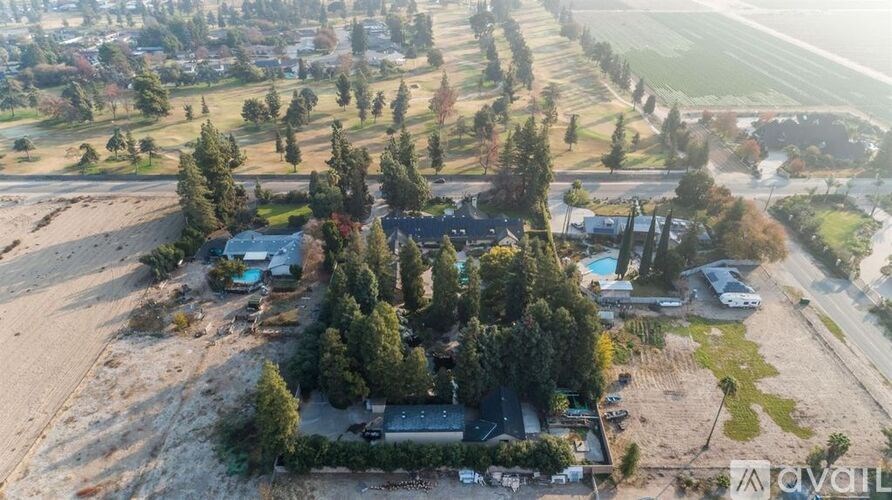 A bird's eye view of a residential area with houses and trees.