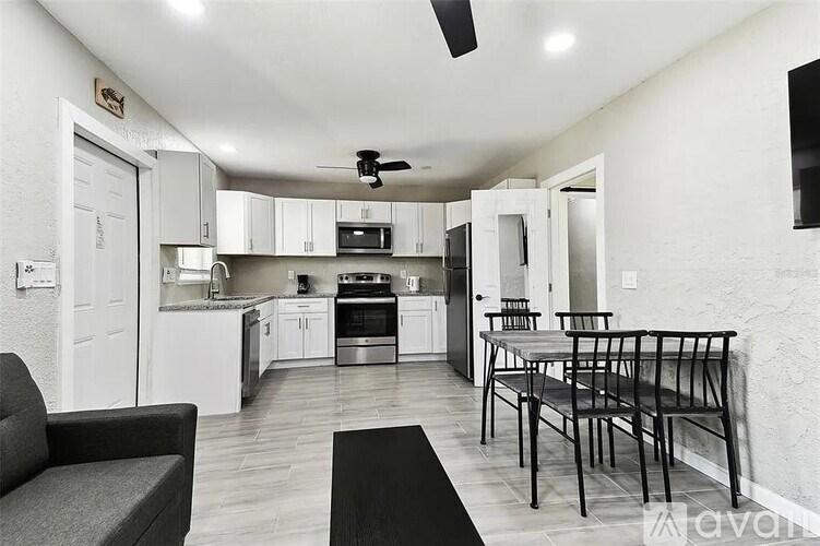 A modern kitchen with a dining table and chairs.