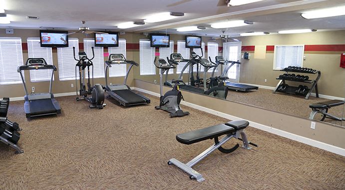 a gym with several pieces of exercise equipment in it