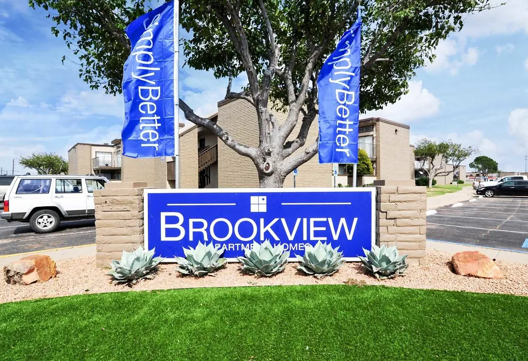a sign for brookview apartments in front of a parking lot
