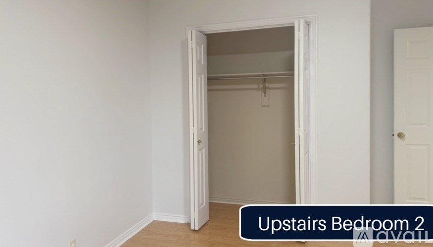 A room with a doorway leading to a bedroom.