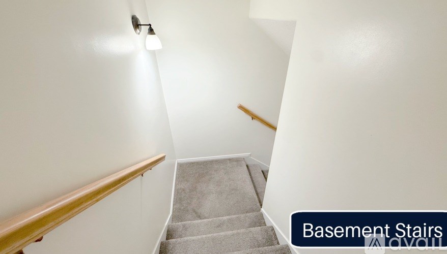 A staircase with a light on the side and a text label "Basement Stairs" on the bottom right.