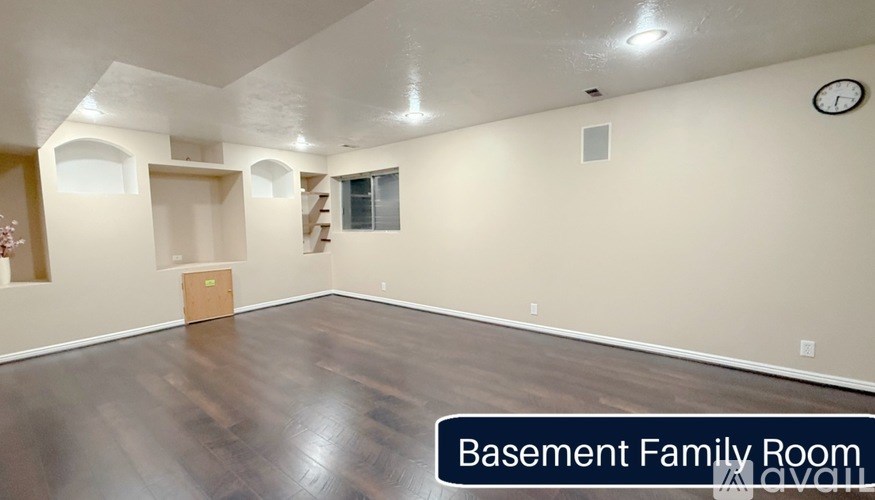 Basement Family Room with wood flooring and arched doorways.