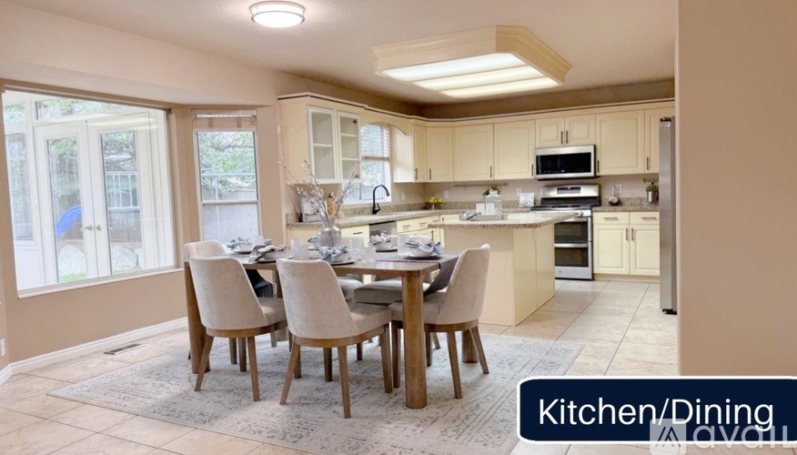 A kitchen and dining area with a table set for four.