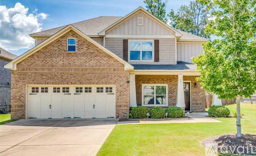 A two-story house with a garage and a tree in front.