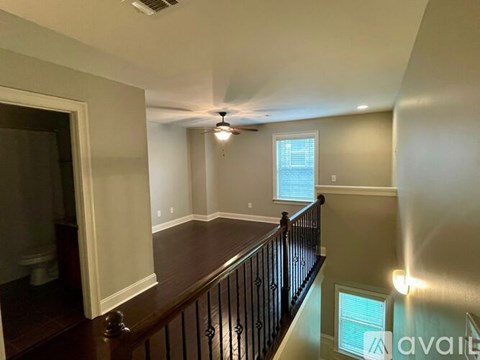 A living room with a ceiling fan and a window.