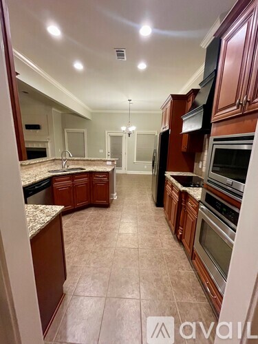 A kitchen with brown cabinets and appliances.