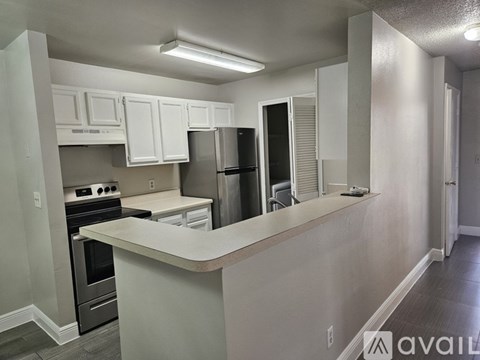 A kitchen with white cabinets and a countertop.