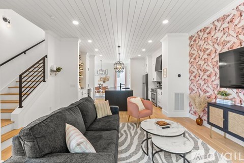 A living room with a grey couch and a zebra print rug.