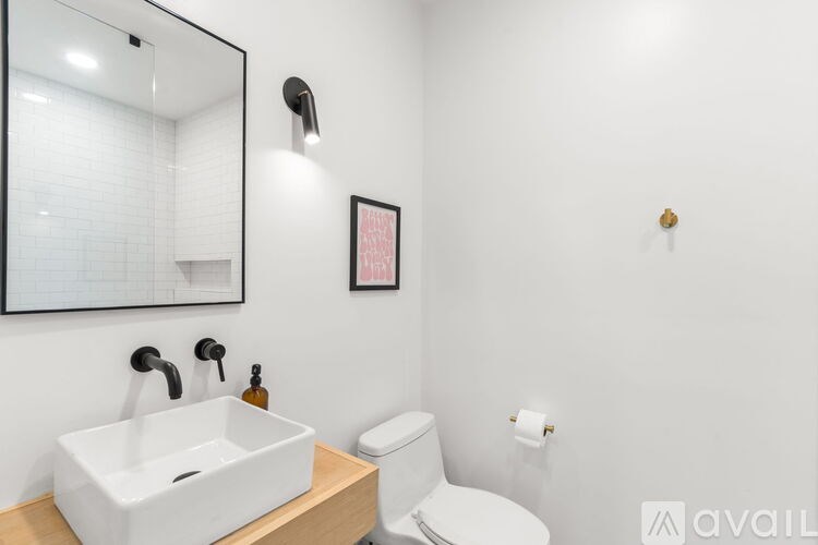 A white sink and toilet in a small bathroom.