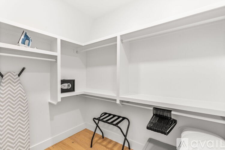 A small room with a chair and a shelf.