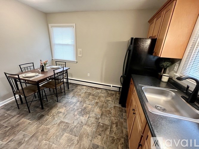 A kitchen with a table and chairs in the middle of the room.