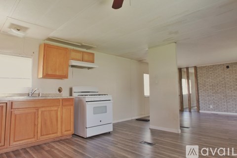 A kitchen with wooden cabinets and a white oven.