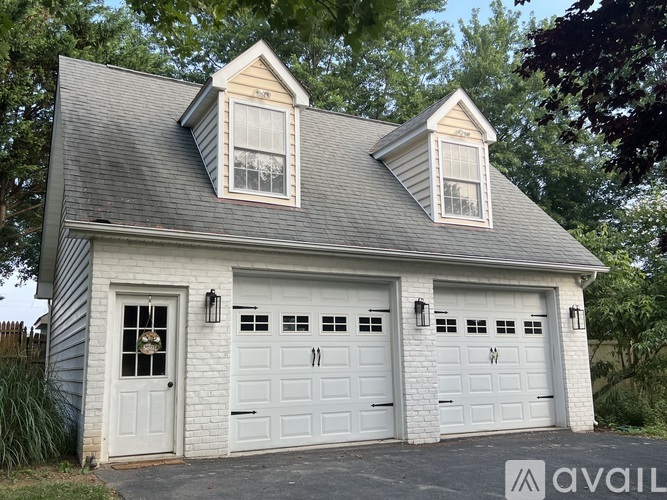 A two-car garage with a white door and windows on the side.